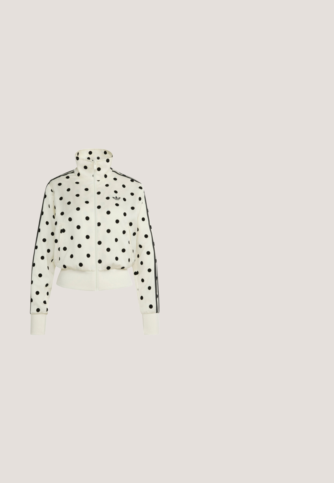 Valkoinen vetoketjullinen takki mustilla pilkuilla, korkea kaulus, sivutaskut, resorit hihansuuissa ja Adidas-logo rinnassa.; Musta lyhythihainen paita, jossa valkoinen reunus kauluksessa ja hihansuissa, valkoiset rei'itetyt raidat olkapäiden ja hihojen varrella, pieni Adidas-logo rinnassa.; Mustat leveälahkeiset housut, joissa joustava vyötärönauha, molemmilla sivuilla kolme valkoista raitaa ja vasemmassa reisessä pieni valkoinen Adidas-logo.; Musta nahkainen litteä kenkä, jossa on valkoiset raidat sivulla, pieni rusettikoriste edessä ja yksi joustava remmi päällä.; Musta suorakulmainen olkalaukku, jossa vetoketjusuljenta ja valkoinen Adidas trefoil -logo edessä keskellä.; Rannekoru epäsäännöllisistä valkoisista helmistä, jossa suuri epäsäännöllinen laventelin sininen helmi keskikoruna ja metallinen lukko.