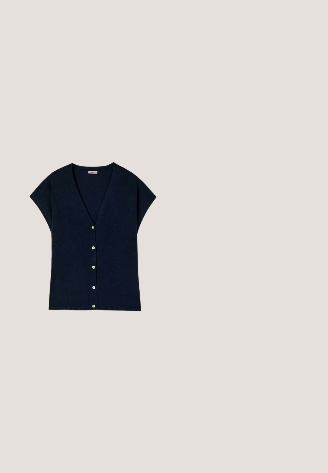 Cárdigan de punto azul marino de manga corta con seis botones blancos y cuello en V, extendido sobre un fondo blanco.; Camisa de botones de manga larga a rayas azul y blanca. Presenta un collar tipo pico y un dobladillo curvado. Fabricada con una tela suave y ligera.; Pantalones negros de pierna ancha con pliegues frontales y una pretina plana, exhibidos sobre un fondo blanco.; Mocasín de ante azul con suela plana, que presenta una banda elevada a lo largo del empeine y detalles sutiles de costura. Textura suave con acentos mínimos.; Bolso tote de cuero azul marino con dos asas largas y un pequeño emblema dorado en forma de media luna en el centro frontal.; Pulsera ajustable con cuentas facetadas azul oscuro, una cuenta blanca con forma de flor en el centro y pequeños acentos dorados sobre un fondo blanco.