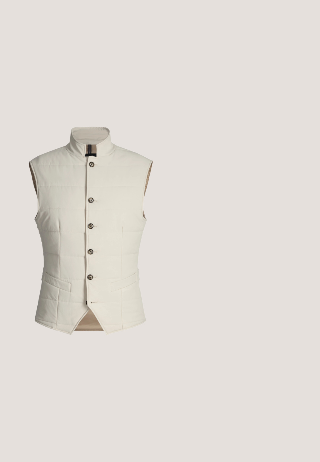 Gilet matelassé sans manches de couleur crème avec col montant, cinq boutons marron et deux poches horizontales à l'avant.; Pull en tricot blanc uni à manches longues, poignets, bas et encolure côtelés, vu de dos.; Chemise en velours côtelé vert olive avec boutons, manches longues, une poche poitrine unique, col pointu et boutons visibles sur le devant.; Pantalons beiges ajustés avec une finition texturée, dotés d'une fermeture à bouton et d'un devant plissé. Taille élastique pour plus de confort.; Botte de randonnée en suède beige avec œillets en métal, semelle marron, boucle de talon noire et logo circulaire embossé à la cheville.; Sac bandoulière olive Tommy Hilfiger avec bordure noire, poche zippée à l'avant, sangle noire ajustable et petit détail de drapeau sur le côté.