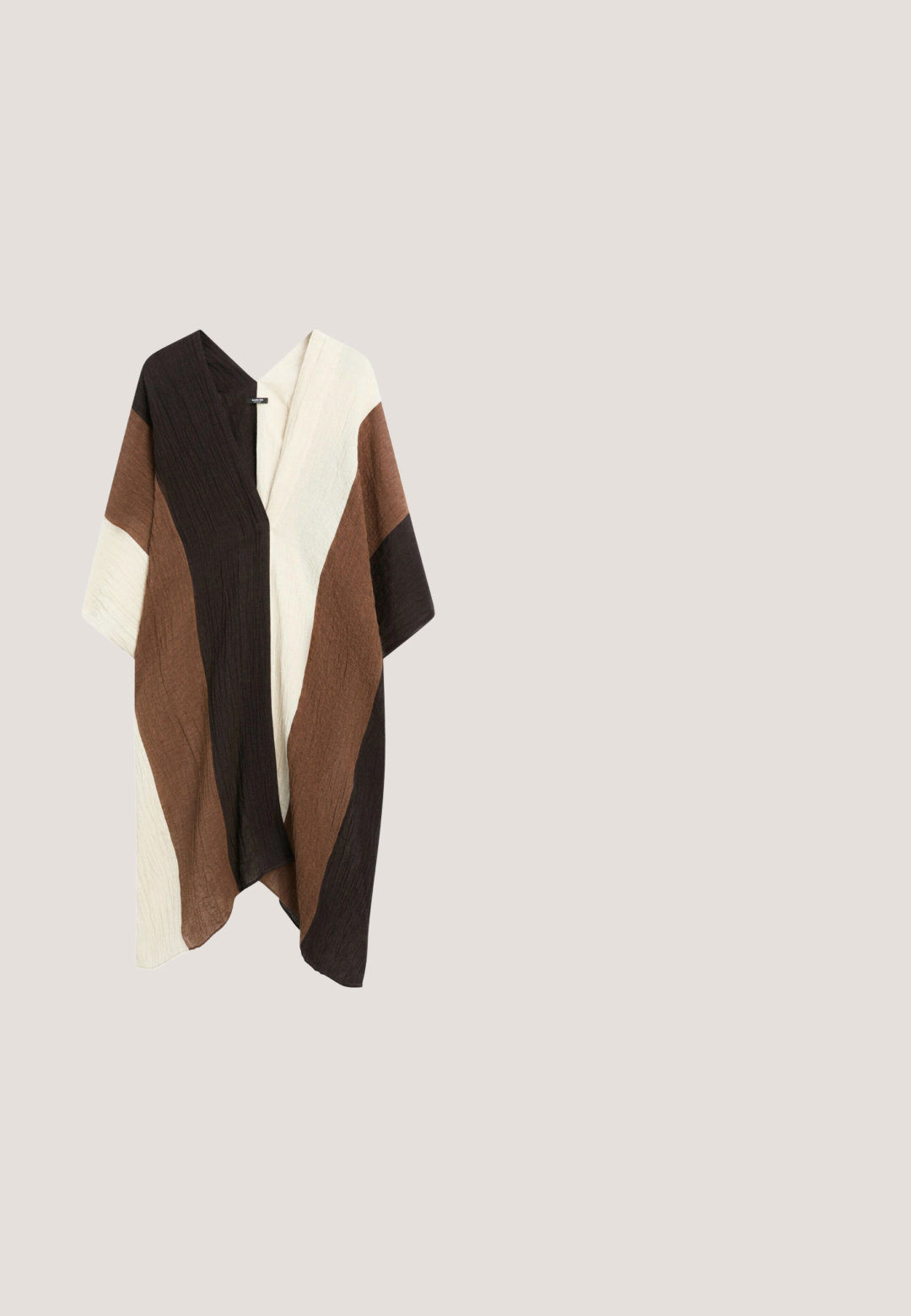 Cardigan ample style kimono avec manches larges en tissu fluide, présentant des blocs de couleurs verticaux en noir, marron et crème.; Haut sans manches en crochet couleur crème avec motifs floraux et bords festonnés, avec une étiquette de marque "NEXT" au niveau de l'encolure.; Jupe noire avec une taille smockée, ornée de motifs abstraits en bordeaux et blanc représentant des feuilles, et d'un tissu plissé pour la texture et le mouvement.; Bottines en daim marron avec un bout pointu, des panneaux élastiques sur les côtés et un petit talon empilé. Comprend une fermeture éclair sur un côté.; Sac à main en cuir marron avec un motif tissé, une anse courbée unique et une fermeture éclair sur le dessus.; Collier avec de petites perles rondes multicolores et des perles en forme de cœur alternées bleu, rouge, orange, vert, jaune et blanc, avec fermoir en or.
