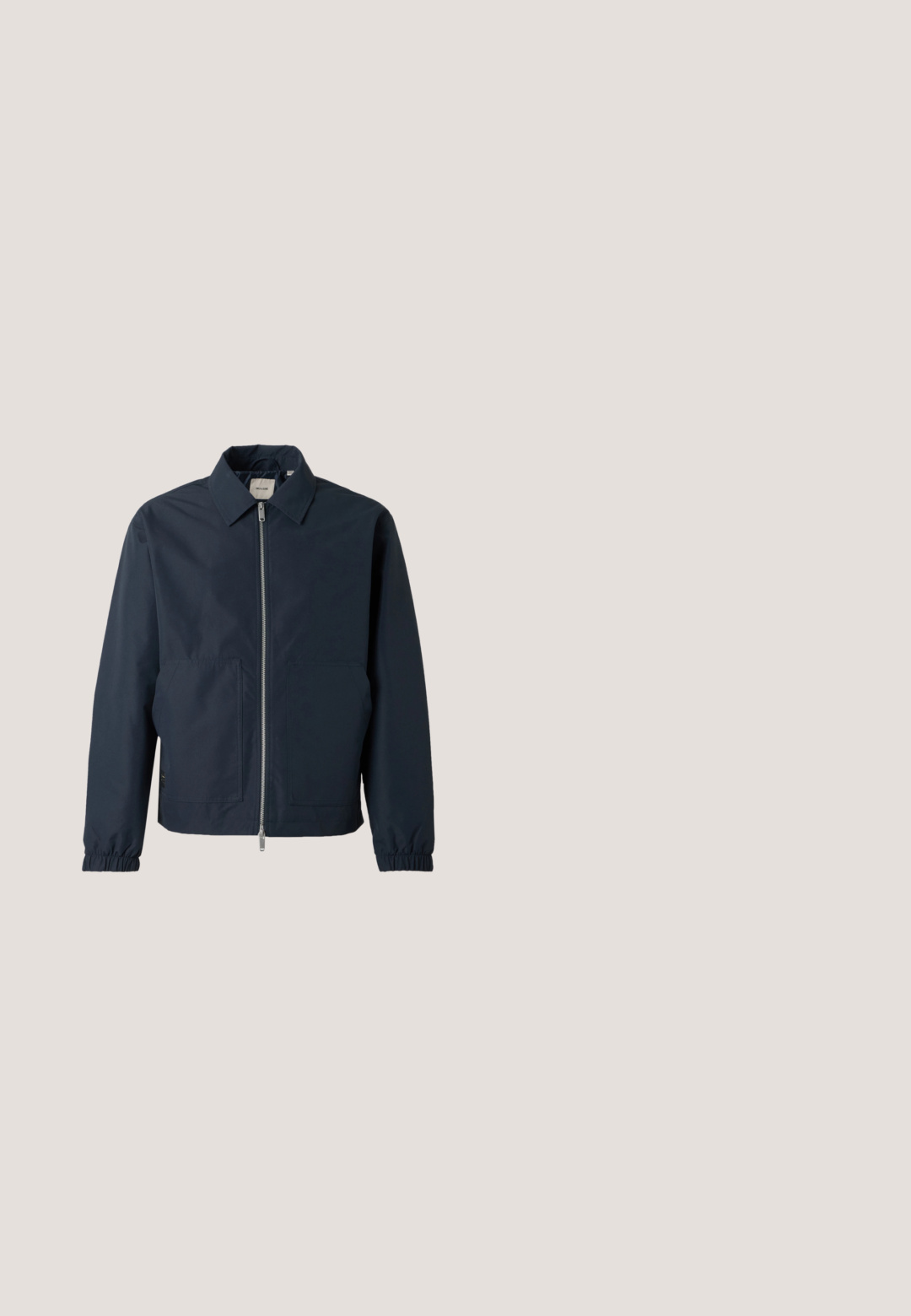 Mørkeblå letvægtsjakke med frontlynlås, spids krave, elastiske manchetter og to store forlommer.; Mørkeblå sweatshirt med høj krave og kvart lynlås. Har et tekstureret panel foran samt ribstrikkede manchetter og kant.; Mørkeblå bomulds T-shirt med rund halsudskæring og korte ærmer. Glat tekstur, lige snit og minimale sømme, hvilket giver et klassisk design.; Beige shorts lavet af letvægtsstof, med elastisk talje, snoretræk og sidelommer med kontrasterende syninger.; Brune læder ankelstøvler med afrundet tå, metaløjer, brune snørebånd og en struktureret gummisål. Har en glat sort hæl-aksecent.; Blå lærredstote taske med frontlomme og rød "O.N.S" broderi, med to håndtag og en justerbar skulderrem.