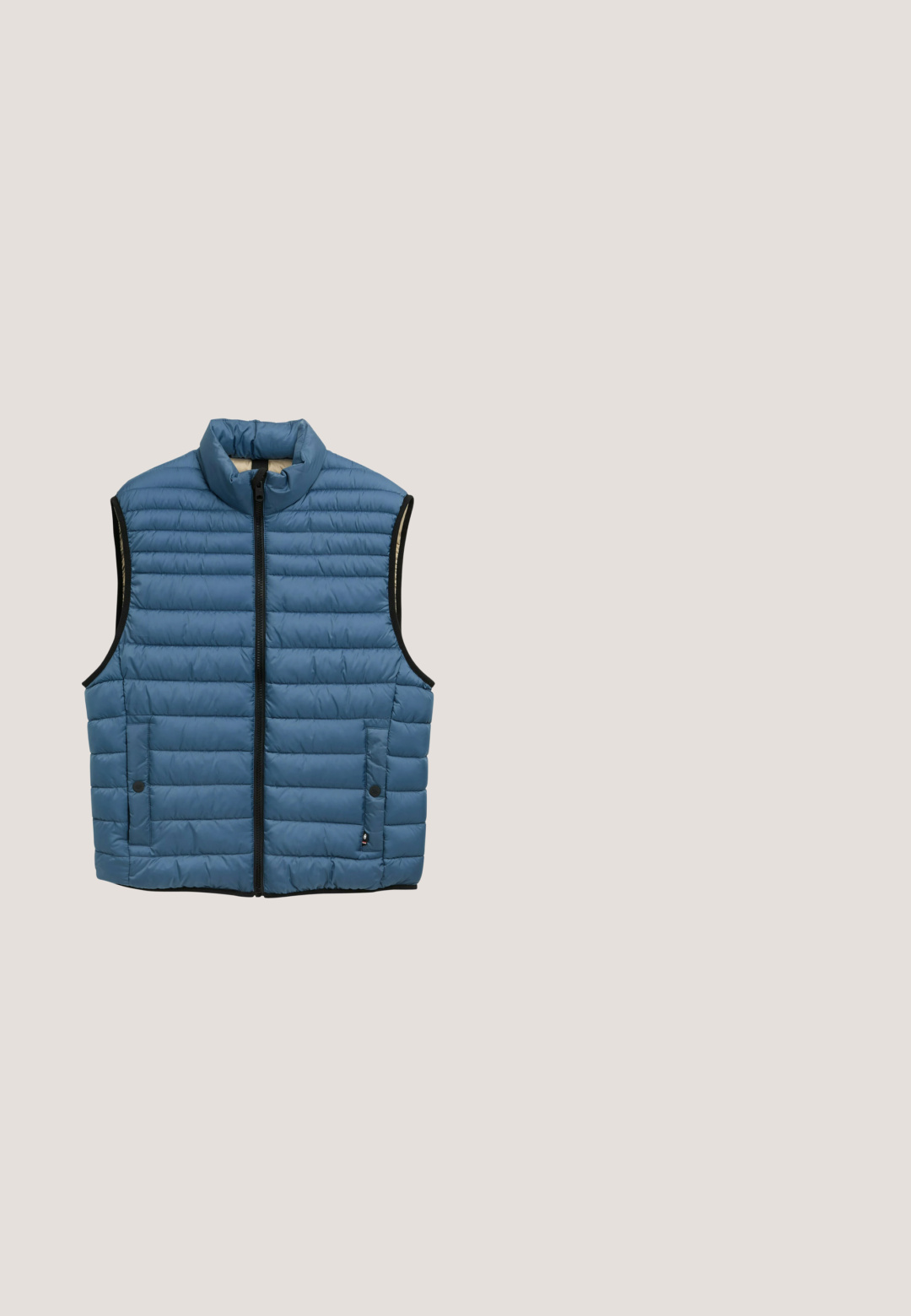 Gewatteerd blauw vest met hoge kraag, voorkant met rits en twee zijzakken. Voorzien van horizontale quilting en zwarte afwerking langs de randen.; Marineblauwe hoodie met een voorklepzak, borstpatch met het label "TOM TAILOR", capuchon met trekkoord en ribbelmanchetten. Soepele stoftextuur.; Marineblauwe katoenen t-shirt met korte mouwen, ronde halslijn, met gedeeltelijk bedrukte witte tekst en cijfers op de voorkant in een casual ontwerp.; Donkergrijze denim jeans met een rechte pijpdesign, voorzakken en knoopsluiting. Bevat subtiele vervaging en stikselaccenten.; Marineblauwe sportschoen met mesh bovenwerk, witte zool, zwarte loopzool en "Tom Tailor" logo op de hielkap.; Zwarte leren crossbodytas met horizontale strepen in donkergroen en marineblauw. Gladde textuur met ritssluiting en verstelbare band.