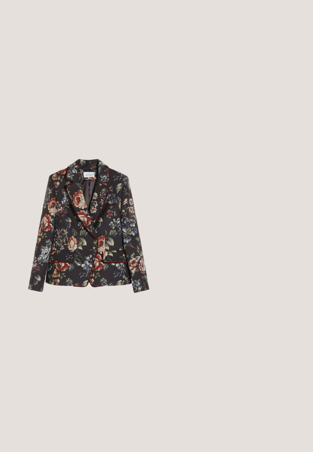 Skræddersyet sort dameblazer med stort flerfarvet blomsterprint, rød piping langs kanterne og to frontlommer med klap og guldknapper.; Gul mønstret bluse med lange ærmer, tekstureret stof, snøre i kanten og blomsterprint i pink og orange. Knappelukning foran.; Gul pailletteret blyantskirt med rynket detaljer foran og bagpå, med en tekstureret overflade og en kant der bliver smallere mod bunden.; Sølv slingback højhælet sko med spids tå og stor dekorativ perleudsmykning foran.; Sort mesh clutch-taske med en struktureret silhuet, prydet med små metalstuds, har en låsemekanisme og en aftagelig kæderekke.; Udsmykket guldbroche med fire blomsterformer lavet af blå, grønne og klare facet skårne ædelstene arrangeret i et symmetrisk mønster.