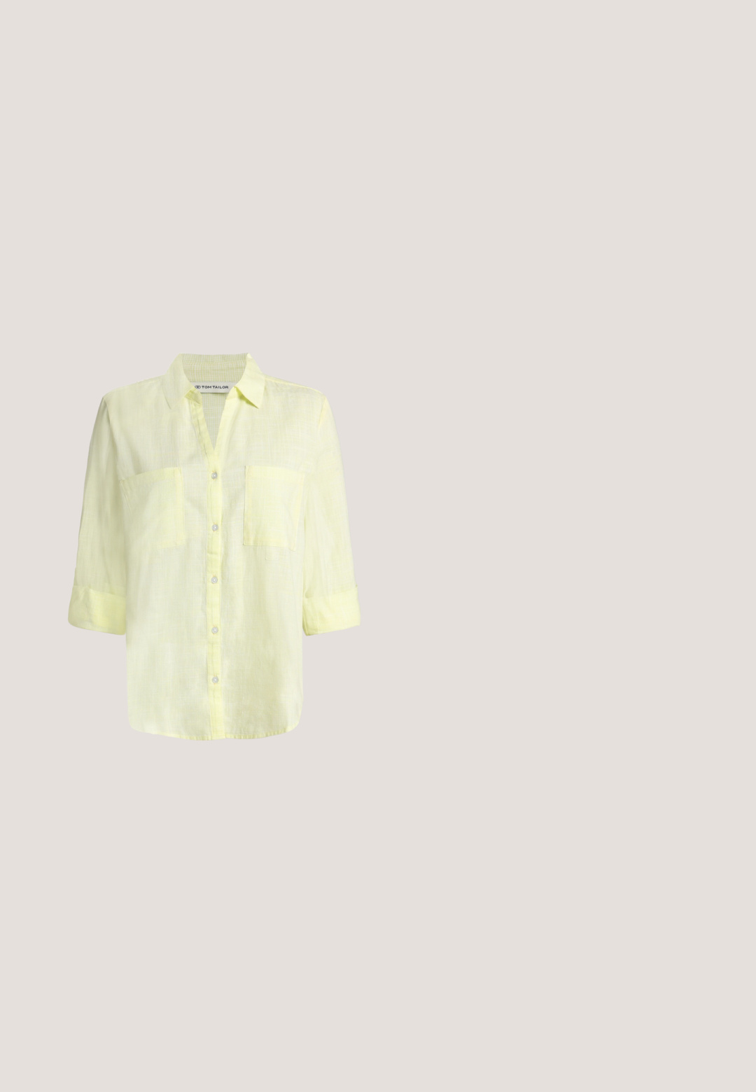 Chemise en lin jaune clair boutonnée, avec col, deux poches poitrine et manches retroussées.; Pantalon beige à jambes larges avec pli frontal, passants pour ceinture, fermeture par bouton et une petite étiquette en tissu sur le côté droit de la ceinture.; Chaussure plate pointue en daim marron avec petit talon et boucle décorative sur le dessus, vue de côté sur fond blanc.; Sac à bandoulière rectangulaire marron avec longues sangles et détails de couture minimalistes sur un fond uni.; Collier chaîne délicate en or avec pierre centrale en ambre, petit charme en or à côté de la pierre et pendentif goutte d'or pendant sur fond blanc.; Ceinture en cuir brun foncé enroulée avec une boucle rectangulaire arrondie dorée et brillante sur un fond uni clair.
