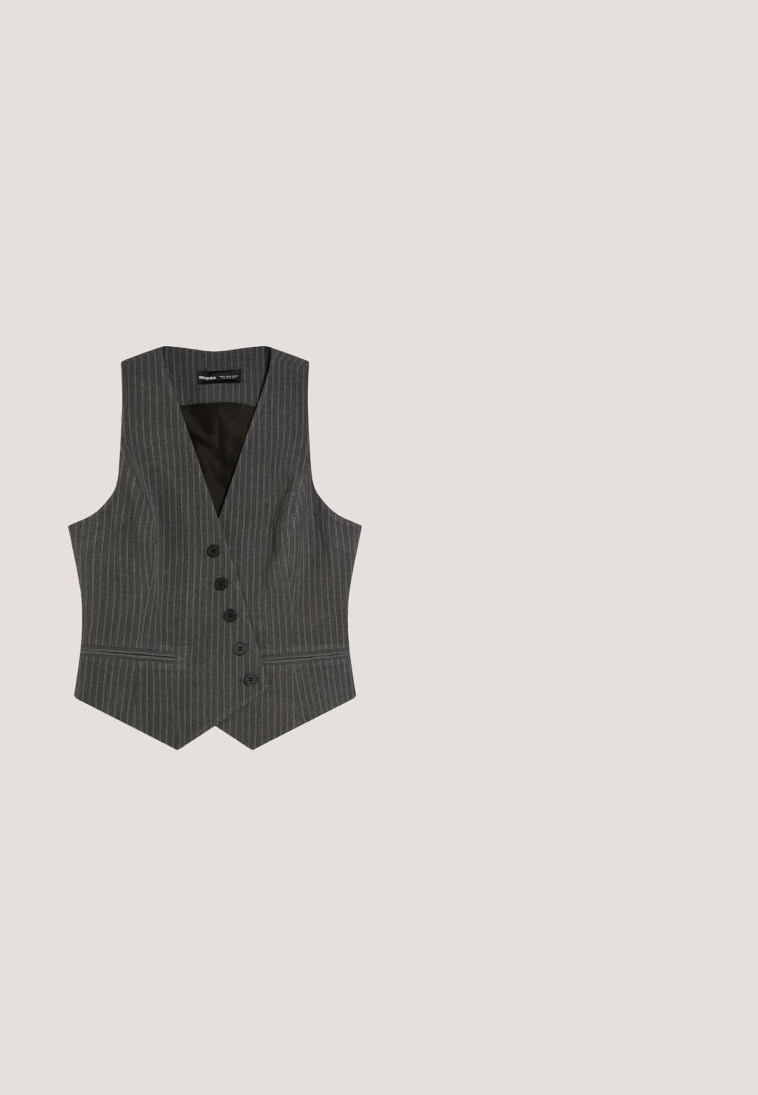 Grijs krijtstreep maatwerk herenvest met vijf zwarte knopen en twee voorzakken met slit, voorzien van een V-hals en een puntige zoom.; Effen grijze kortemouwen gebreide T-shirt met een ronde halslijn en een klein zwart label aan de binnenkant van de kraag.; Grijs- en witgekleurde stof met een visgraatpatroon en plooien, met een zwart knoopdetail op de tailleband. Zachte textuur, op maat gemaakt ontwerp.; Mango Instappers - black; Slanke rechthoekige zonnebril met donkergroene glazen en een dun zwart metalen montuur, met pootjes in schildpadmotief.; Zwarte gestructureerde leren handtas met twee lange banden en goudkleurige rechthoekige hardware accenten bij de handvatten.