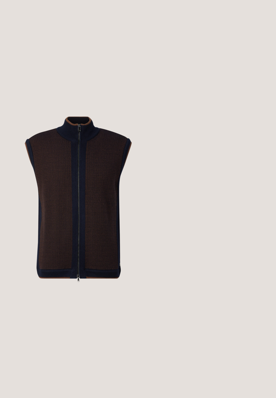 Mouwloos bruin en marineblauw gebreid vest met rits, hoge kraag en een gestructureerd patroon op de voorkanten.; Bruine lange mouwen shirt gemaakt van zachte stof met een knopsluiting aan de voorkant, een klassieke kraag en witte knopen langs de sluiting.; Roodkleurige broek met een gestructureerd patroon, voorzien van een knoopsluiting, riemlussen en schuine zijzakken. Recht afgesneden ontwerp.; Bruine suède herenschoenen met veters, zwarte zool, lage hak en subtiele zijstiksels, op witte achtergrond.; Bruine rechthoekige leren toilettas met ritssluiting en metalen Aston Martin-logo aan de voorkant.; Bruine geperforeerde leren riem met zilverkleurige rechthoekige gesp en "JOOP!" geperst op de riemlus, plat opgerold op een witte achtergrond.