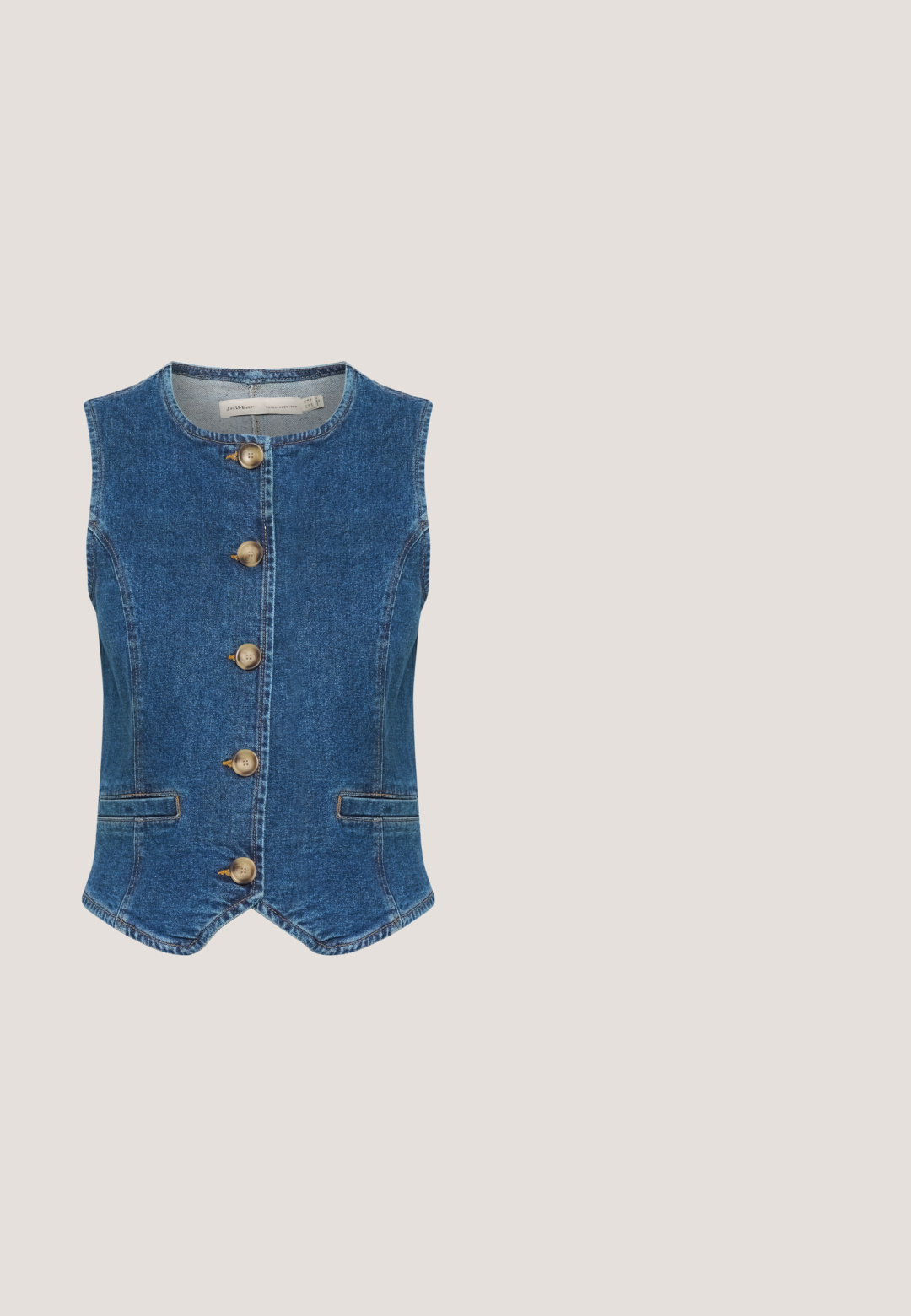 Chaleco de denim en azul oscuro con escote redondo, que presenta cinco grandes botones dorados en el frente y dos bolsillos laterales. Textura suave.; Camiseta de algodón azul marino con mangas cortas y cuello redondo. Presenta texto dorado "RÊVER GRAND" y un diseño floral en el centro.; Pantalones cortos azul marino hasta la rodilla con rayas verticales blancas, cierre de botones, trabillas para cinturón y bolsillos laterales.; Zapatillas de mezclilla azul con bordado floral blanco, entresuela de cuerda texturizada y cordones blancos. Suela plana de goma. Diseño de corte bajo.; Bolso hobo azul tejido con una sola correa azul oscuro y dos pompones colgando de un lado.; Pendientes de aro dorados con una banda de patrón estrellado, que presentan acentos de flores en azul y blanco con un elemento decorativo central.