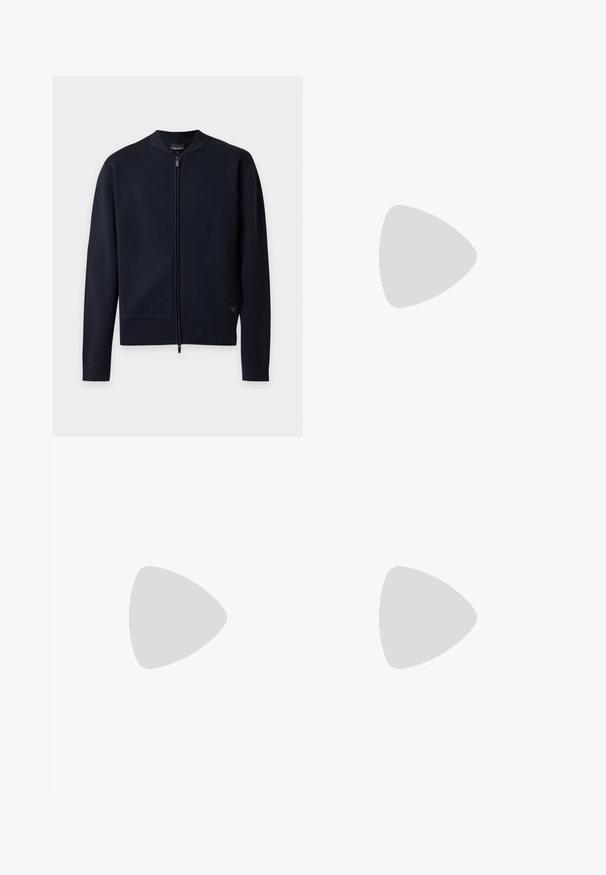 Cardigan en maille bleu marine avec fermeture éclair intégrale, col, poignets et bas côtelés, présenté à plat sur un fond clair.; T-shirt beige à manches courtes avec col rond et une petite étiquette noire à l'intérieur du col portant la mention Michael Kors.; Short de bain bleu marine avec coutures blanches, taille élastique, poches latérales et fermeture à nouer sur le devant.; Baskets en cuir bleu marine avec semelle en caoutchouc crème, dotées de lacets bleus et d'une texture lisse. Bout arrondi et design minimaliste.