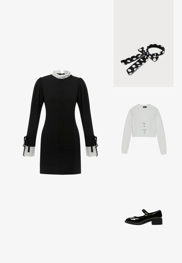 Even&Odd by Zalando Cardigan - 001 - white; Sort kjole med høj hvid krave, knappelukning foran og lange ærmer med plisserede hvide manchetter med snore. Glat stoftekstur.; Sort laklæder Mary Jane sko med lav blokhæl og rund guldlås rem på hvid baggrund.; Sort stofhårbånd med hvide polkaprikker bundet i en sløjfe med to løse ender mod en hvid baggrund.