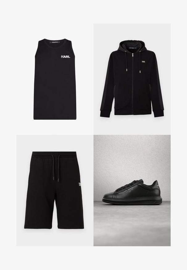 Zwarte hoodie met ritssluiting, trekkoorden, zijzakken en een klein rechthoekig logo op de linkerborst.; Zwart mouwloos tanktop van glad katoen, met een witte "KARL" logo op de linkerborst. Eenvoudig, recht ontwerp.; Zwarte knielange shorts met elastische tailleband en trekkoord, voorzien van een kleine witte logotekst op de rechterdij.; Persoon die zwarte Karl Lagerfeld sneakers draagt met een zwarte broek, staand op een houten parketvloer tegen een witte gepaneelde muur.