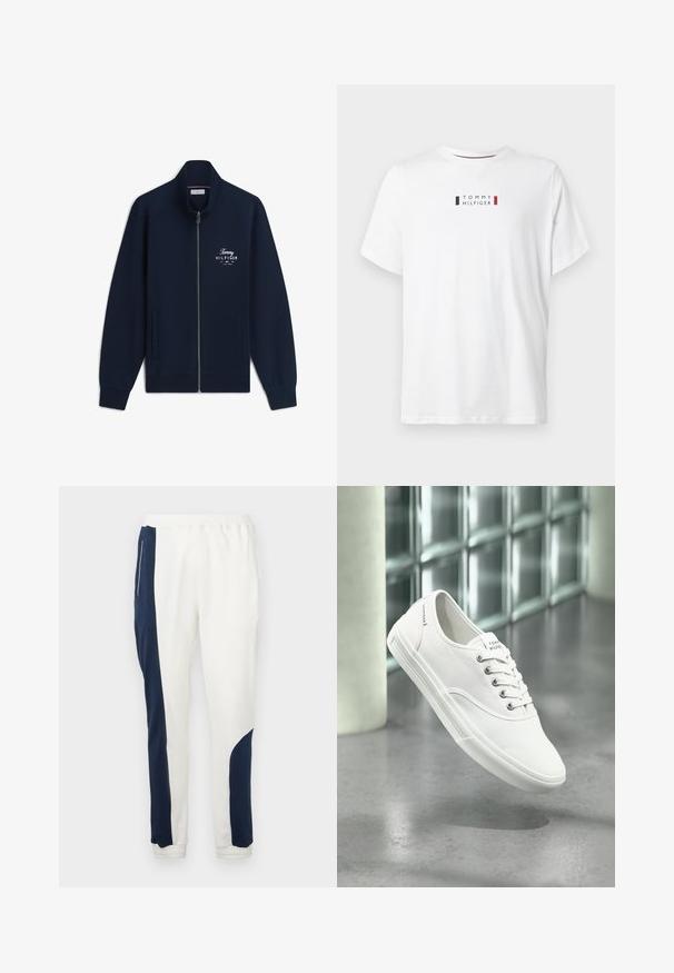 Tmavomodrá bunda so zipsom, vysokým golierom, prednými vreckami a bielym logom Tommy Hilfiger na ľavej hrudi s nápisom „EST. 1985 NEW YORK.“; Biela bavlnená tričko s okrúhlym výstrihom. Jeho centrálny logo so čiernymi a červenými akcentmi znie "TOMMY HILFIGER." Krátke rukávy.; Biele teplákové nohavice so námornícky modrými bočnými panelmi a elastickými manžetami, vyrobené z mäkkého materiálu s hladkou textúrou a sťahovacím pásom.; Biely nízky plátený teniska s šnúrkami, označený Tommy Hilfiger, zobrazený, ako sa vznáša nad hladkou sivou podlahou pri stene zo sklenených blokov.