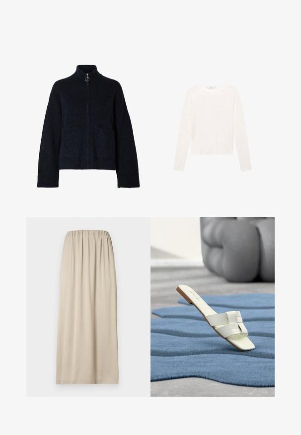 Sort, blød jakke med lynlås, høj krave, lange ærmer, to forlommer og sølvfarvet ring på lynlåsen.; Langærmet hvid top lavet af blødt stof. Har en rund halsudskæring og et cropped design. Glat tekstur uden synlige mønstre eller detaljer.; Beige knælængde nederdel lavet af blødt stof med elastik i taljen. Har en glat tekstur og et enkelt, flydende design.; Hvid flad slidesandal med brede remme på et blåt tekstureret tæppe og en sløret grå stor pude i baggrunden.