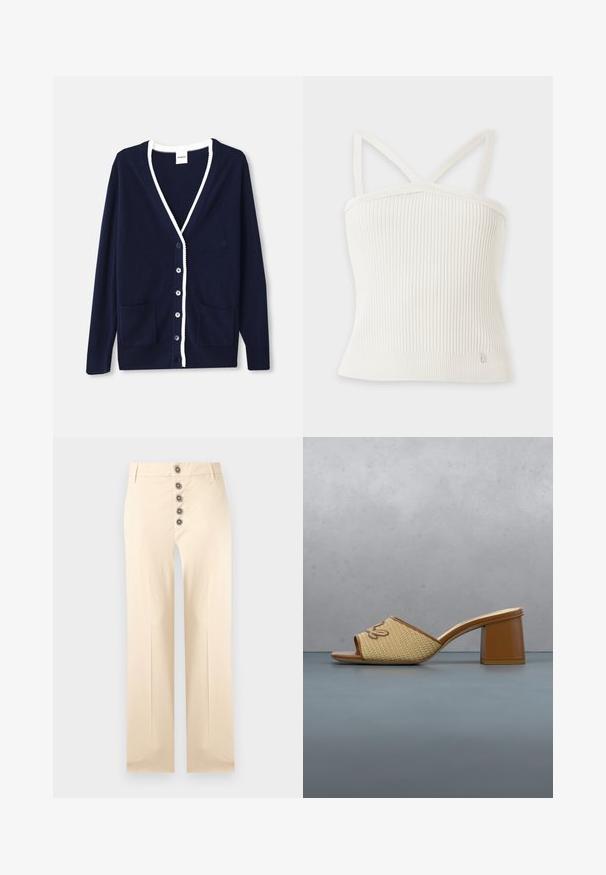 Marineblauwe cardigan van zacht materiaal, met een V-hals, witte accentrand, vijf knopen en twee voorzakken. Tijdloos ontwerp met subtiele accenten.; Witte geribde gebreide cropped top met dunne schouderbandjes en een klein metalen merklabel nabij de onderzoom.; Beige broek met hoge taille, voorzien van vijf decoratieve ronde bruine knopen aan de voorkant en rechte, wijde pijpen.; Bruine clog met hak en gevlochten band met "Karl" borduursel, geplaatst op houten tegels met een groene plant en een stenen muur op de achtergrond.