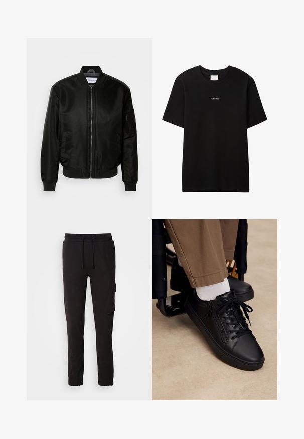 Chaqueta bomber negra hecha de nailon brillante, con cremallera frontal, puños y dobladillo acanalados, y un bolsillo con cremallera en la manga izquierda.; Camiseta de algodón negra con cuello redondo y mangas cortas. Presenta un pequeño logo blanco "Calvin Klein" en el frente. Ajuste clásico y suave.; Pantalones jogger negros de mezcla de algodón, con cinturilla elástica con cordón, bolsillos laterales y un bolsillo tipo cargo en el muslo.; Zapatilla deportiva de cuero negro con cordones y cremallera lateral, usada con calcetines blancos y pantalones marrones, pie apoyado en el reposapiés de una silla de ruedas.