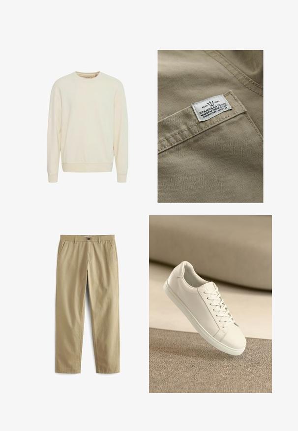 Khaki stof med en struktureret overflade, der har et hvidt mærke syet på en lomme – teksten inkluderer "ESTD 1982," "STANDARD ISSUE" og forsyningsreference.; Lys beige sweatshirt, rund hals, lange ærmer, blød stof, ribbede manchetter og kant, sidesplitter for lettere bevægelse, minimalistisk design.; Beige bukser lavet af en bomuldsblanding, med knaplukning, to forlommer og lige ben med minimal tekstur.; Hvide lædersneakers med hvide snørebånd, præsenteret på en beige tekstureret overflade og med en blødt uskarp baggrund.