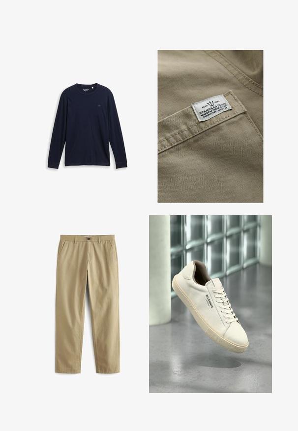 Khaki tkanina s textúrovaným povrchom, s bielou nášivkou na vrecku - text obsahuje "ESTD 1982," "STANDARD ISSUE" a referenciu na dodávku.; Námornícke tričko s dlhým rukávom vyrobené z mäkkej bavlny, so zaobleným výstrihom, prešívanými lemami a malým vyšívaným logom na hrudi.; Béžové nohavice vyrobené z bavlneného zmesi, s gombíkovým zapínaním, dvoma prednými vreckami a nohavicami s priamej strihom s minimálnou textúrou.; Biela plátenná teniska s béžovou podrážkou a šnúrkami, logo "AllSaints London" na boku, vznášajúca sa nad sivou leštenou podlahou blízko sklenených blokov.