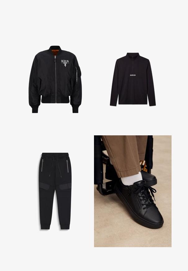 Cazadora bomber negra hecha de tejido brillante con puños y dobladillo acanalados, que presenta un cierre frontal, gráfico "BERLIN" y un bolsillo con cremallera en la manga.; Jersey de manga larga negro de Calvin Klein con cremallera de cuarto y logo blanco impreso en el pecho.; Pantalones jogger negros con cintura elástica, cordones, bolsillos laterales con cremallera y detalle adicional de tela en los muslos, tobillos con puños.; Zapatilla deportiva de cuero negro con cordones y cremallera lateral, usada con calcetines blancos y pantalones marrones, pie apoyado en el reposapiés de una silla de ruedas.