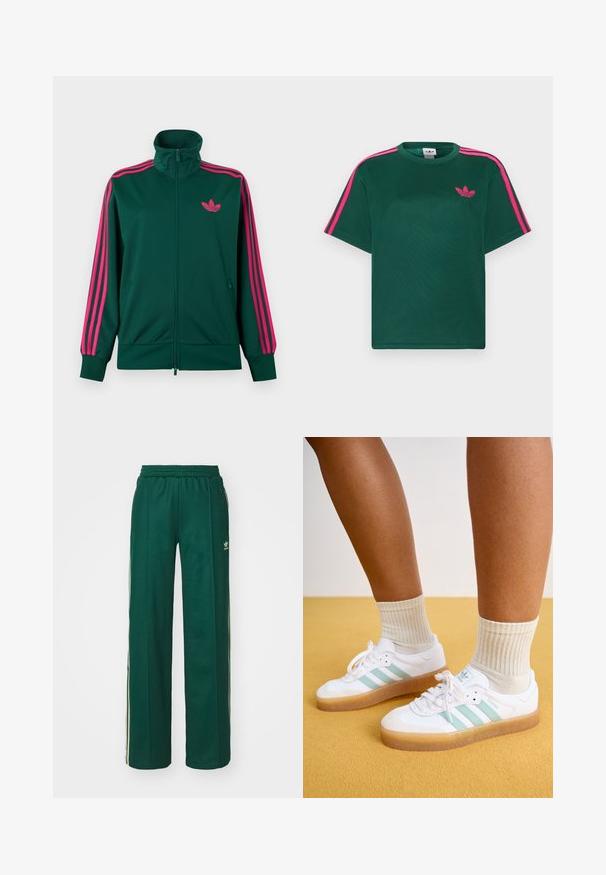 Mørkegrøn lynlås-træningsjakke med høj krave, lyserøde tre-stribe detaljer på ærmerne og lyserødt Adidas trefoil-logo på brystet.; Grøn kortærmet t-shirt med lyserøde striber på skuldrene og Adidas trefoil-logo på brystet.; Mørkegrønne træningsbukser med en afslappet pasform, der har snor i taljen, sidelommer og cremefarvede striber langs siderne.; Hvite sneakers med mintgrønne striber, gummisål og snørebånd, parret med ribbede cremefarvede sokker. Sat mod en gul baggrund.