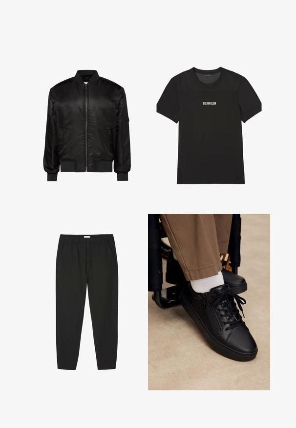 Chaqueta bomber negra con cremallera frontal, cuello, puños y dobladillo acanalados, y dos bolsillos delanteros con cremallera sobre fondo blanco.; Camiseta negra de manga corta Calvin Klein con tejido de malla en los hombros y la parte superior del pecho, con el nombre de la marca impreso en blanco en el centro del pecho.; Pantalones negros con cintura elástica, piernas rectas y bolsillos laterales, diseñados para uso casual o profesional.; Zapatilla deportiva de cuero negro con cordones y cremallera lateral, usada con calcetines blancos y pantalones marrones, pie apoyado en el reposapiés de una silla de ruedas.