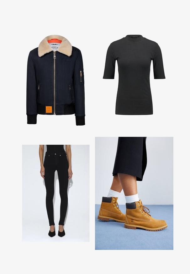 Marine bomberjack met een nepbontkraag, gouden rits, ribgebreide manchetten en een oranje voering. Heeft een oranje label aan de voorkant.; Zwarte geribbelde T-shirt met een hoge hals en korte mouwen. Gladde, aansluitende pasvorm zonder patronen of zichtbare hardwaredetails.; Persoon die zwarte skinny jeans met hoge taille en zwarte puntige pumps draagt, staand tegen een effen witte achtergrond.; Tan suède enkellaarsjes met bruine leren accenten, gouden oogjes en een getextureerde zool. Witte sokken zichtbaar boven de laarsjes.