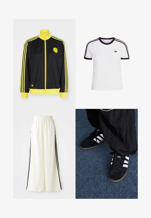 Schwarze Zip-Jacke mit gelben Akzenten, hohem Kragen, Smiley-Gesicht-Logo auf der linken Brust und drei horizontalen gelben Streifen an jedem Ärmel.; Weißes kurzärmliges T-Shirt mit schwarzen Akzenten, mit rundem Ausschnitt und drei schwarzen Streifen auf jeder Schulter. Kleines schwarzes Logo auf der Brust.; Weiße weite Hosen mit elastischem Bund und schwarzen vertikalen Streifen an den äußeren Nähten.; Schwarze Wildleder-Sportschuhe mit drei weißen Streifen und schwarzen Schnürsenkeln. Eine strukturierte schwarze Hose ist teilweise neben den Schuhen sichtbar.