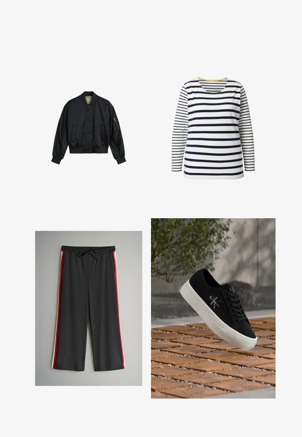 Zwarte bomberjack gemaakt van glad nylon. Beschikt over een hoge kraag, ribgebreide manchetten en zoom, twee voorzakken en een ritszak op de mouw.; Langarmshirt van katoen met horizontale marineblauwe en witte strepen, ronde hals en een klein oranje detail aan de zoom.; Zwarte broek met een elastische tailleband en trekkoord, met rode en witte strepen aan de zijkanten. Gemaakt van soepel, lichtgewicht stof.; Zwarte lage sneaker met witte zool en "Calvin Klein"-logo, zwevend boven een gestructureerd bakstenen oppervlak met groen en een betonnen muur op de achtergrond.