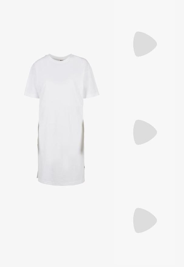 Robe t-shirt blanche à manches courtes, en coton, avec une coupe décontractée, un col rond et des fentes latérales à l'ourlet pour faciliter les mouvements.; Tongs en caoutchouc rouge avec semelle texturée et fines brides brillantes sur fond blanc.; Lunettes de soleil carrées noires avec des verres vert foncé, présentant des montures audacieuses et des accents argentés sur les côtés. Fabriquées en Italie.; Collier en ton or avec une fine chaîne et un pendentif en forme de V. Design épuré avec une finition lisse et polie et un minimum de détails.