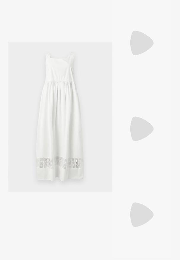 Robe longue blanche sans manches avec taille froncée et bande découpée à motifs près de l'ourlet, présentée sur fond gris.; Chaussure plate noire avec un bout pointu, fabriquée en tissu texturé, avec un accent à nœud et un petit talon rond. Sangle élastique au niveau de la cheville.; Sac hobo tissé noir avec une structure souple et une poignée intégrée, présenté sur un fond clair uni.; Boucles d'oreilles en argent avec des maillons ovales allongés, présentant une finition polie et un pendentif tombant texturé. Design simple avec des bords lisses.