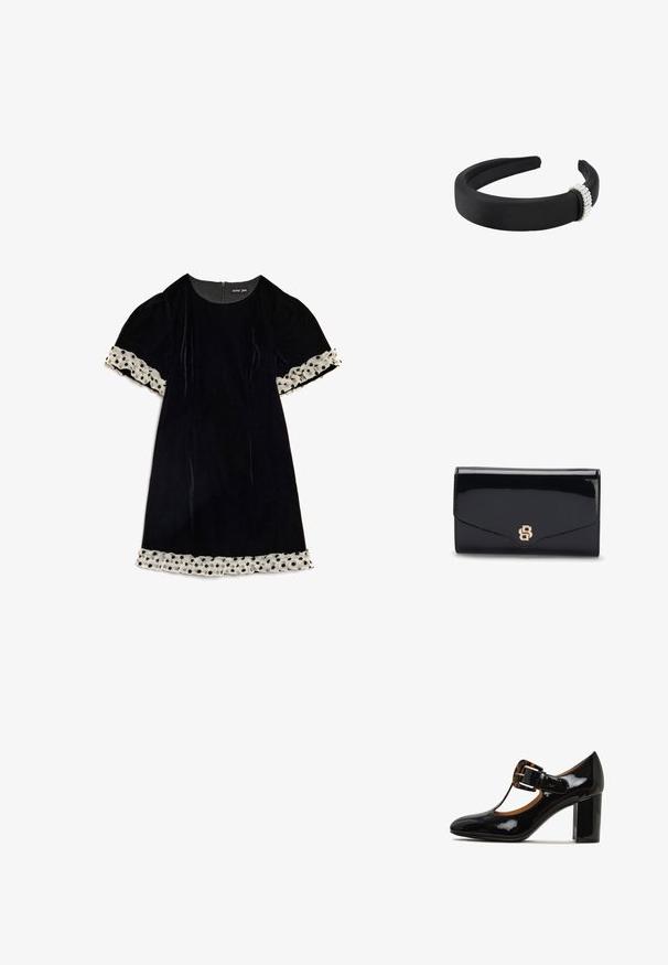 Robe en velours noir avec manches courtes bouffantes ornées d'un ruban de dentelle blanche à pois aux poignets et à l'ourlet, fermeture éclair dans le dos.; Chaussure à talon haut en cuir verni noir avec un bout rond, un design à lanière T, et un accent de boucle en écaille sur le dessus. Talon large.; Pochette en cuir noir brillant avec un logo B entrelacé doré sur le rabat avant, montrée fermée sur fond blanc.; Bandeau noir rembourré avec un groupe de petites perles blanches attachées d'un côté sur fond blanc.