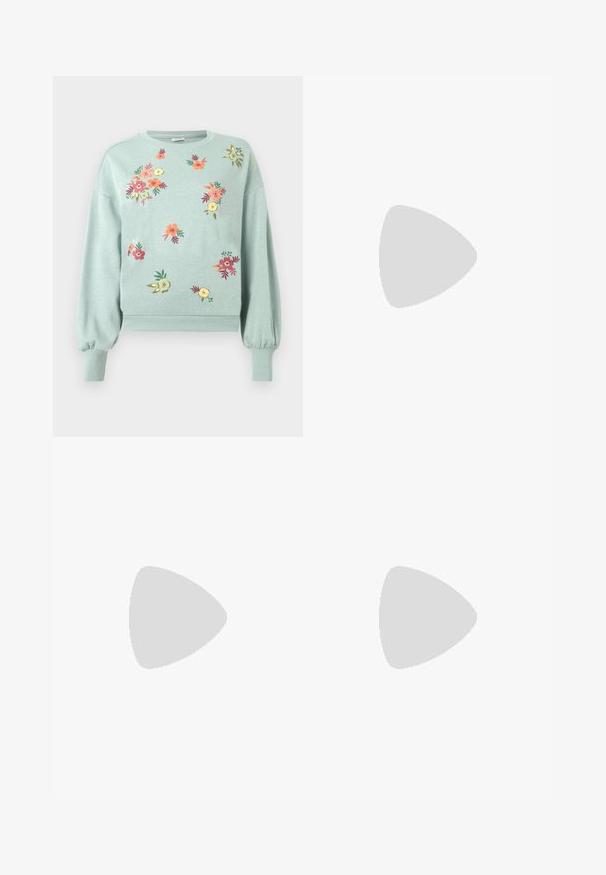 Sweatshirt vert clair avec broderies florales en rose, orange et jaune. Il présente des poignets et un ourlet côtelés, avec une coupe décontractée et des manches ballon.; Pantalon en denim foncé à jambes larges, doté d'une taille élastique avec cordon de serrage, de coutures orange contrastantes et de lignes droites et épurées.; Chaussure plate slingback blanche pointue avec deux boucles argentées, présentée en extérieur sur un sol texturé et un mur carrelé en arrière-plan.; Sac à main en cuir tressé blanc avec poignée arrondie et extrémités de lanière nouées, présenté sur un fond uni.