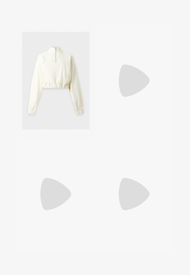 Langærmet cremefarvet cropped sweatshirt med høj krave og halv lynlås, med elastisk talje og manchetter.; Nike Sportswear TANK - Top - amber brown/sail; Hvide sweatpants lavet af et blødt stof, med elastisk talje med snøre, sidelommer og et sort Nike-logo på venstre lår.; Hvide lædersneakers med gyldne detaljer, rund tå, perforeret design på tåboksen og flade snørebånd. Har 'Air' branding på sålen.