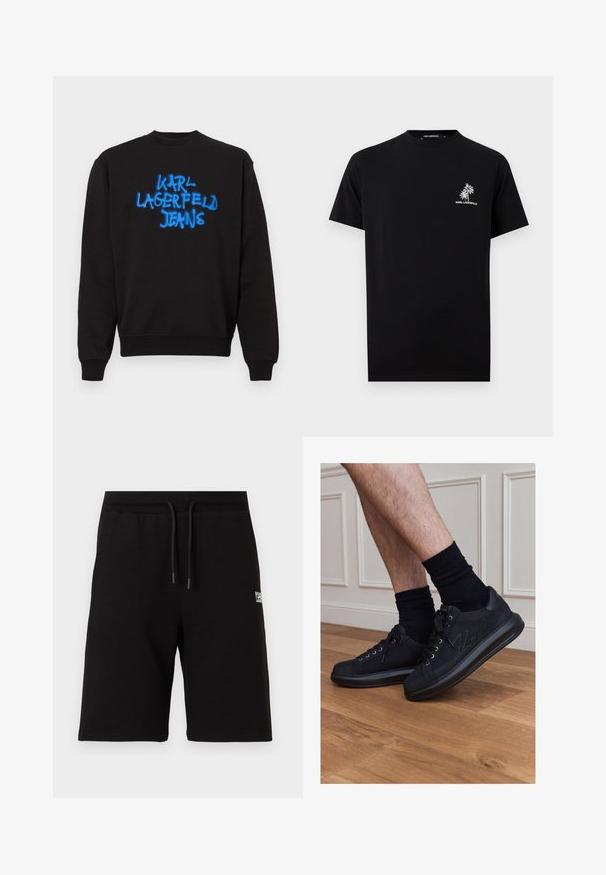 Black crewneck sweatshirt with long sleeves and blue graffiti-style text "KARL LAGERFELD JEANS" on the front center.; Black short-sleeve t-shirt with small white palm tree graphic and "KARL LAGERFELD" text on left chest.; Black knee-length shorts with elastic waistband and drawstring, featuring small white logo text on the right thigh.; Person wearing black sneakers with laces and black socks standing on wooden floor against white wall paneling.