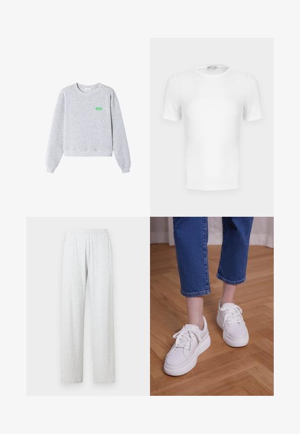 Lichtgrijze sweater met ronde hals en lange mouwen, geribbelde boorden bij de mouwen en zoom, en kleine groene "American Vintage" tekst op de linkerborst.; Witte korte mouwen geribde T-shirt met een ronde hals, een aangesloten pasvorm en een klein merklabel aan de binnenkant van de kraag.; Lichtgrijze broek van katoenmengsel met een elastische tailleband en twee zijzakken. Recht model met een zachte, licht gestructureerde afwerking.; Benen met cropped blauwe jeans en witte vetersneakers met plateauzool, staand op een lichte houten vloer.