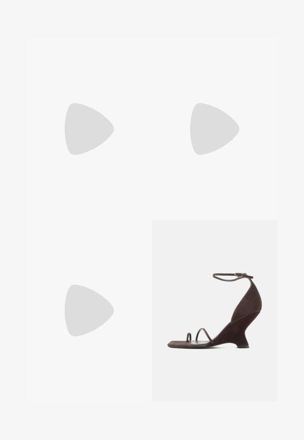 Combinaison marron sans bretelles avec corsage ajusté et pantalons larges, drapés et plissés créant une silhouette fluide.; Sandale à talon haut en daim marron foncé avec talon compensé sculpté, bride de cheville avec boucle et deux fines lanières au niveau des orteils sur une semelle plate.; Sac en cuir tressé marron avec une forme courbée et structurée, doté de deux poignées tressées, présentant une surface texturée et un design sans couture.; Boucles d'oreilles créoles en or massif avec un design tubulaire légèrement tordu et des fermoirs à tige sur un fond blanc.