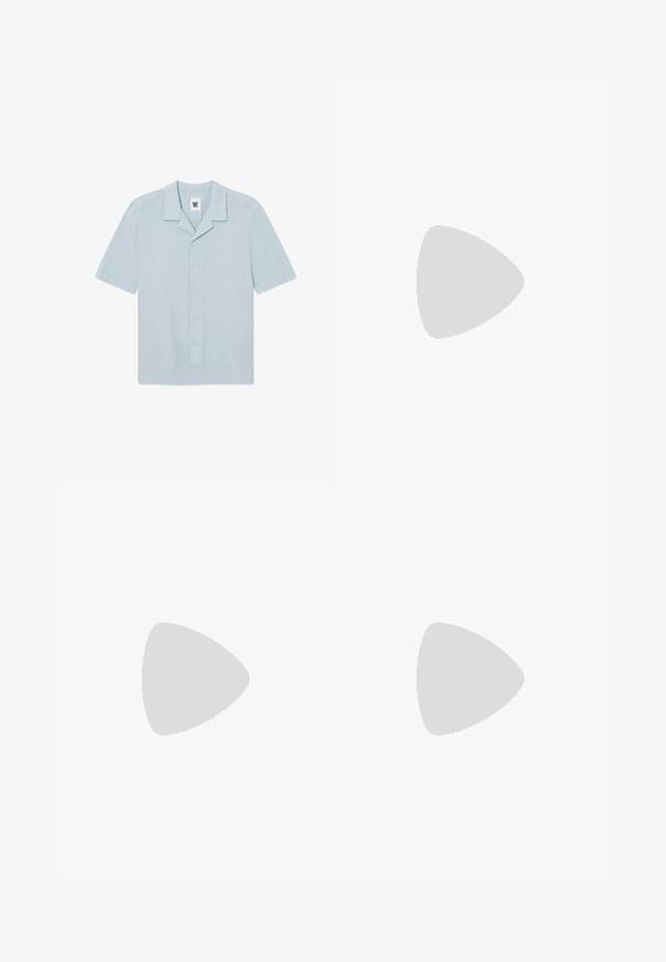 Chemise à manches courtes bleu clair en tissu texturé. Présente un col à entaille, une fermeture par bouton, et un petit logo brodé sur la poitrine.; Pantalon noir taille haute, sur-mesure, avec passants pour ceinture, plis sur le devant, fermeture par bouton et jambes droites larges sur fond clair.; Chaussure brogue en cuir noir avec semelle épaisse à rainures et fermeture à lacets sur fond uni gris clair.; Ceinture en cuir noir enroulée avec une boucle rectangulaire en métal argenté, marquée d'un petit texte "NN.07" sur le bord inférieur de la boucle.