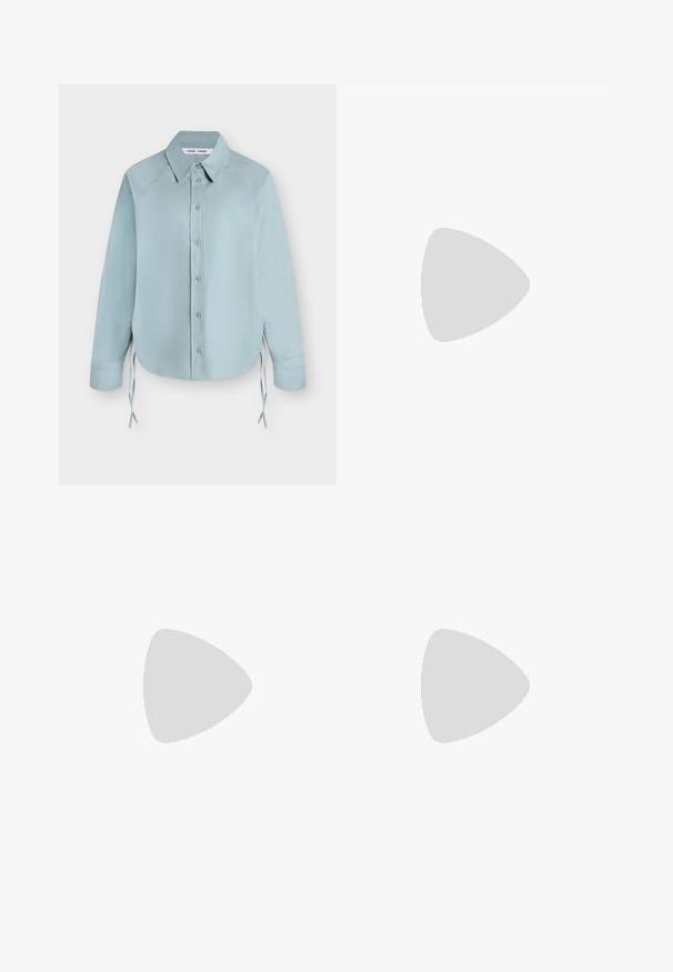 Chemise bleu clair à manches longues boutonnée avec col pointu et liens latéraux, présentée à plat sur fond blanc.; Shorts ajustés couleur crème avec pli devant et passants de ceinture, présentés sur fond blanc.; Ballerines noires en cuir avec un bout pointu, une semelle plate et une petite sangle avec un détail de boucle en argent.; Sac à épaule en cuir vert avec un design arrondi, poche zippée à l'avant et poches supplémentaires sur les côtés. Texture lisse et matériel minimal.