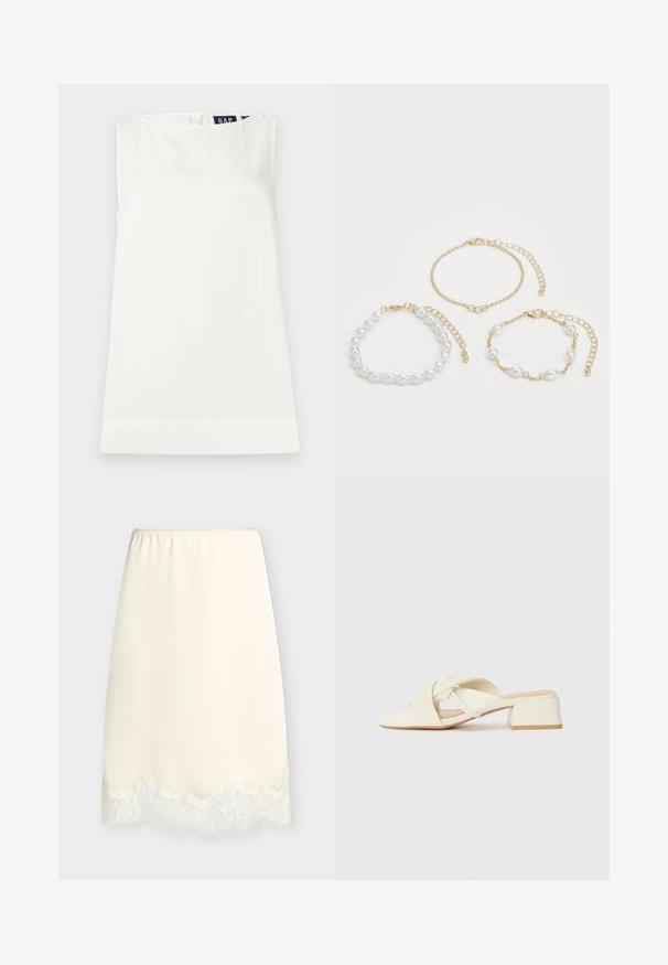 Haut blanc sans manches à col rond avec une petite étiquette GAP visible au niveau de l'encolure arrière, posé à plat sur un fond clair.; Demi-jupon couleur crème avec taille élastique et bordure en dentelle le long de l'ourlet, présenté sur un fond clair uni.; Sandales à talons bloc couleur crème avec des brides torsadées et un lit de pied plat. Matériau synthétique lisse avec une finition mate.; Trois bracelets : un avec des perles blanches, une chaîne en or avec des accents de cristal, et un avec des maillons mélangés en or et en perles. Les tons dorés dominent.