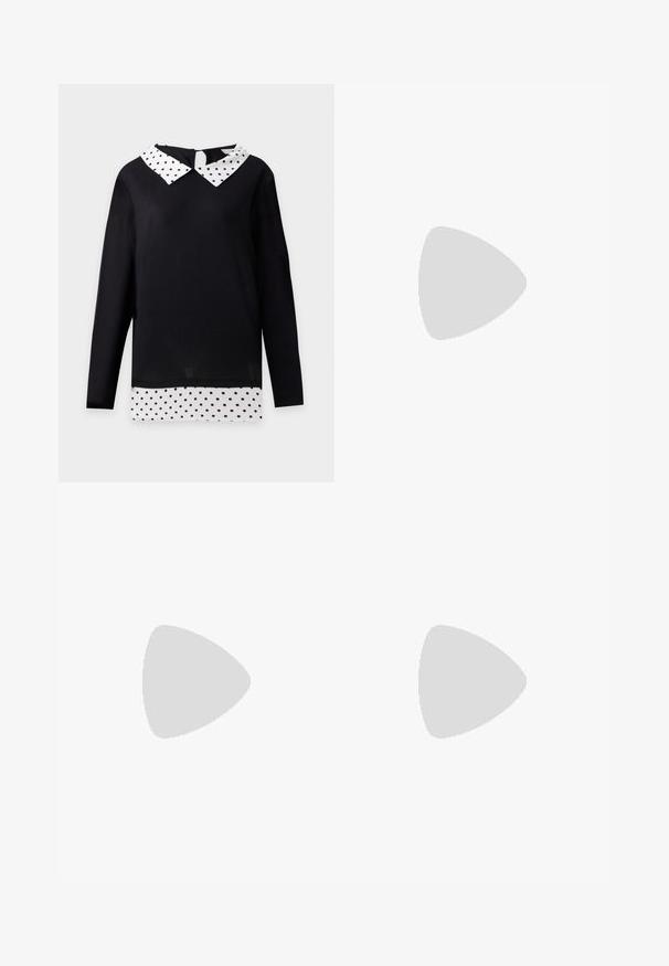 Sort langærmet top med hvid krave og kant med sorte prikker, stylet til at ligne en lagdelt skjorte.; Beige bomuldsbukser med skræddersyet design, der har knaplukning, forreste folder og en oprullet kant for ekstra detaljer og struktur.; Ben iført mørke ribbede leggings kombineret med sorte balletsko med små sløjfedetaljer på hvid baggrund.; Vævet håndtaske i sort og hvid med en rund form, tekstureret overflade og et fletet håndtag. Velegnet til afslappet brug.