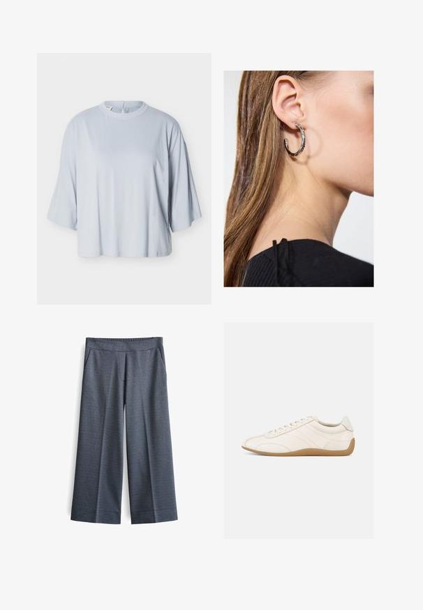 Lichtblauw loszittend shirt met brede mouwen tot de elleboog en een ronde hals, getoond op een effen witte achtergrond.; Wijde broek in donkergrijze stof. Voorzien van een elastische tailleband, twee voorkantzakken en een gladde textuur met een subtiel patroon.; Witte leren sneaker met een gladde textuur, ronde neus en tonale stiksels. Voorzien van een tankleurige rubberen zool en vetersluiting.; Zilveren oorbel met een gepolijste afwerking, met kleine gouden accentdetails en een ronde vorm, gedragen op de oorlel.