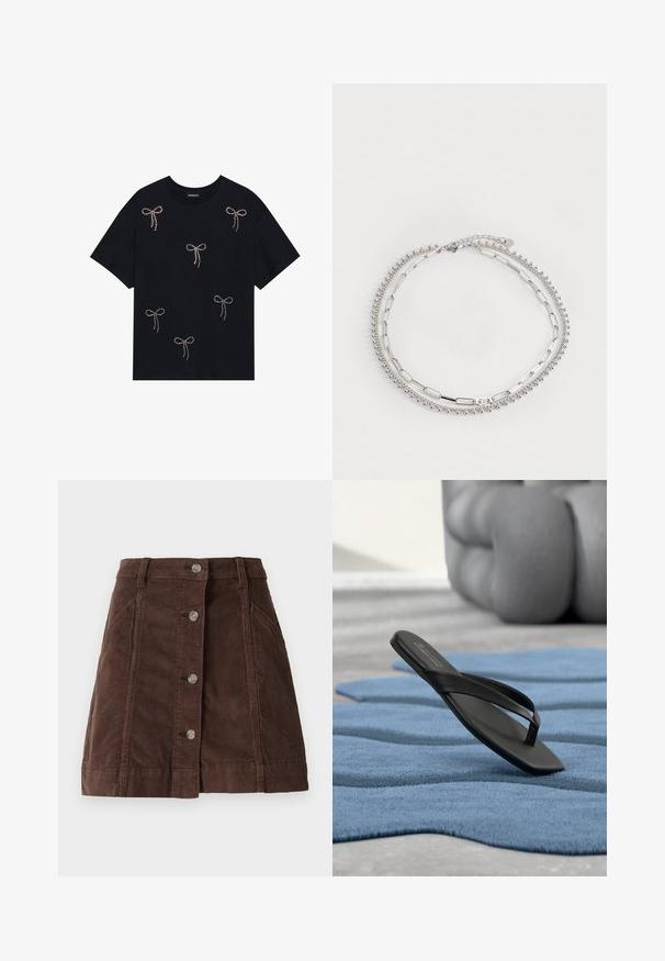 Schwarzes Baumwoll-T-Shirt mit mehreren mit Strass verzierten Schleifenmotiven auf der Vorderseite. Rundhalsausschnitt und kurze Ärmel.; Brauner Cord-Rock im A-Linien-Schnitt mit vorderem Knopfverschluss und Seitentaschen, mit Gürtelschlaufen und vertikalen Nahtdetails.; Einzelne schwarze Flip-Flop-Sandale liegt auf einem strukturierten blauen Teppich, mit einem unscharfen, abgerundeten Sofa im Hintergrund.; Silberarmband mit drei Strängen: einer mit kleinen Perlen, einer mit ovalen Gliedern und einer mit flachen Stangen. Verfügt über eine Kettenverlängerung für Anpassungsfähigkeit.
