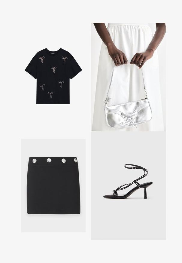 Schwarzes Baumwoll-T-Shirt mit mehreren mit Strass verzierten Schleifenmotiven auf der Vorderseite. Rundhalsausschnitt und kurze Ärmel.; Schwarzer Minirock mit breitem Bund, der oben vier große silberne Metallösen gleichmäßig verteilt aufweist.; Schwarze Wildleder-High-Heelsandalen mit spitzem Zehenbereich, Knöchelriemen und dekorativen Nietenverzierungen an den Riemen.; Silberne metallische Handtasche mit Schnürdetail, die ein elegantes Design und einen kurzen Tragegurt aufweist. Die Tasche wird in den Händen gehalten und zeigt ihre Textur.