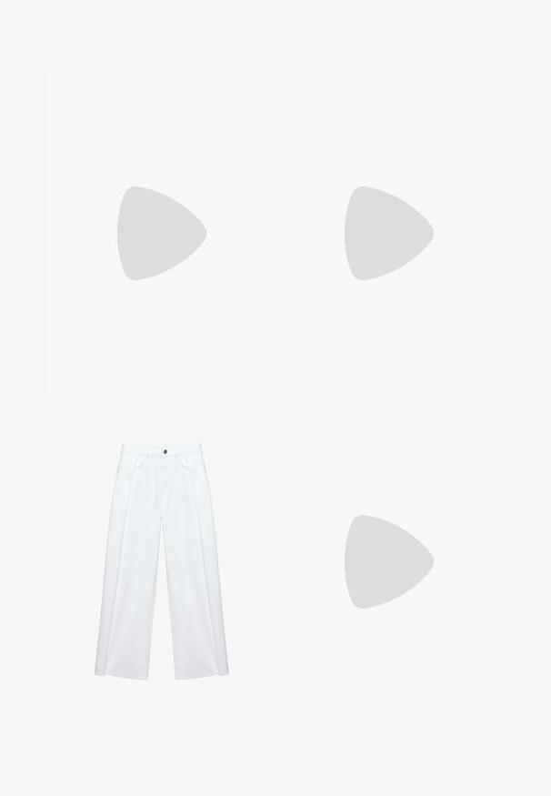 Top tube beige en tricot avec un grand motif floral marron foncé au centre et un cordon à nouer sur le bord supérieur.; Pantalon blanc à jambes larges avec plis devant, passants de ceinture, poches latérales et fermeture par bouton et zip.; Baskets Adidas noires avec des bandes blanches et une semelle beige, capturées en plein air au-dessus d'une surface en pierre et d'un mur en pierre en arrière-plan.; Petit sac à main noir brillant avec deux longues anses et des détails à cordon sur les côtés sur un fond clair uni.