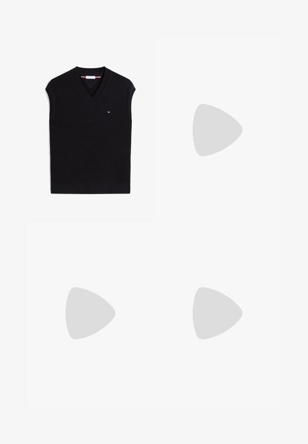 Chaleco de punto negro sin mangas con escote en V y pequeño logo rojo, blanco y azul en el lado izquierdo del pecho.; Camisa blanca de manga larga con botones, cuello abotonado y pequeño logo bordado en el pecho izquierdo.; Pantalones cortos blancos hasta la rodilla con trabillas para cinturón, cierre frontal con botones y bolsillos laterales sobre un fondo liso.; Mocasines de cuero negro con punta redondeada, costuras decorativas y una suela baja y plana. Textura suave, diseño minimalista sin adornos.