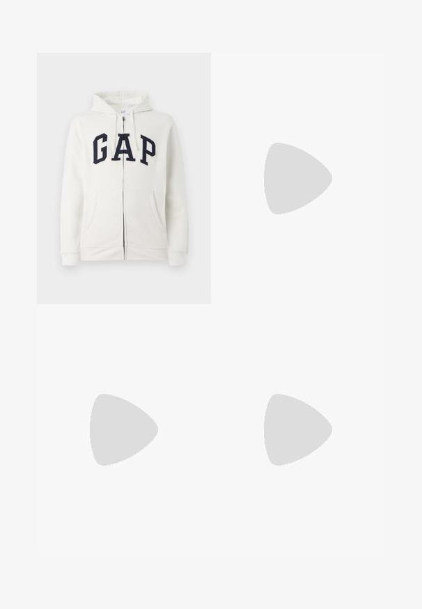Krémová mikina na zips z jemného materiálu, na prednej strane s veľkým námorníckym logom "GAP", dvoma prednými vreckami a kapucňou.; Biela bavlnená tričko s krátkymi rukávmi, s oranžovým logom na ľavej hrudi a rovný strih na leme.; Čierne denímové nohavice s rovnými nohavicami, s piatimi vreckami, gombíkovým zapínaním a čistým dizajnom. Odolná tkanina s matným povrchom.; Biele kožené tenisky s šedou semišovou špičkou, tromi horizontálnymi bielymi pruhmi, modrým akcentom a hnedou gumovou podrážkou. Textúrovaný detail na podrážke.