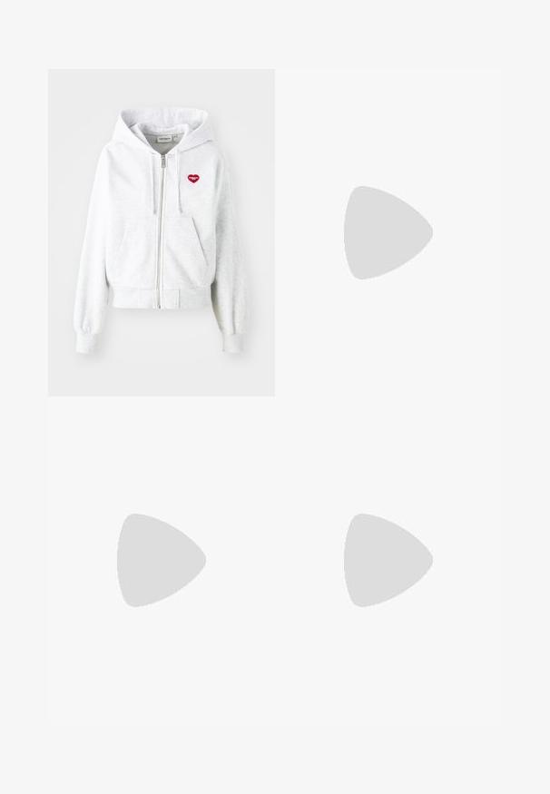 Light gray zip-up hoodie with a kangaroo pocket, ribbed cuffs, and a red heart logo on the left chest. Soft cotton blend material.; White long-sleeve cropped top in textured fabric, featuring a rounded neckline and three button closure at the front.; Beige denim shorts featuring a high waist, five pockets, a button closure, and contrast stitching, with a slightly faded texture.; Beige and white sneaker with a smooth leather and suede finish, featuring a padded tongue, lace-up front, and visible air cushioning unit.