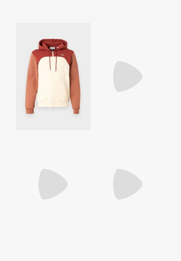 Felpa con cappuccio e zip, con una parte frontale crema, spalle e maniche color ruggine, e un piccolo logo verde sul petto. Tessuto morbido.; T-shirt bianco a maniche corte in cotone con colletto a coste, caratterizzato da strisce verdi e nere; piccolo logo ricamato verde sul petto sinistro.; Jeans azzurri chiari in denim, con taglio dritto, design a cinque tasche e chiusura a bottone visibile con cuciture in contrasto.; Sneakers bianchi con una texture liscia, caratterizzate da un accento verde sul tallone e un piccolo logo ricamato a forma di coccodrillo sul lato.