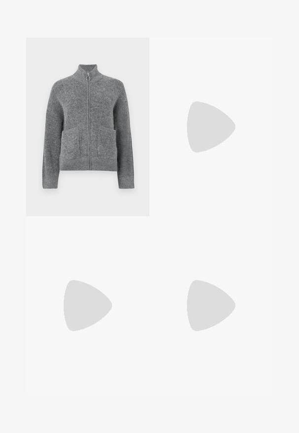 Gray knit cardigan with a high collar, zip closure, and two front pockets. Features a soft texture and ribbed cuffs and hem.; White ribbed tank top featuring a black embroidered logo centered on the chest. The neckline and armholes are finished with a subtle binding.; Dark denim jeans with a wide-leg cut, featuring a mid-rise waist, front pockets, back pockets, and contrasting stitching. Raw hem detail.; Brown suede sneakers with white accents and laces. Rubber gum sole. Worn with white socks featuring black stripes. Green textured flooring.