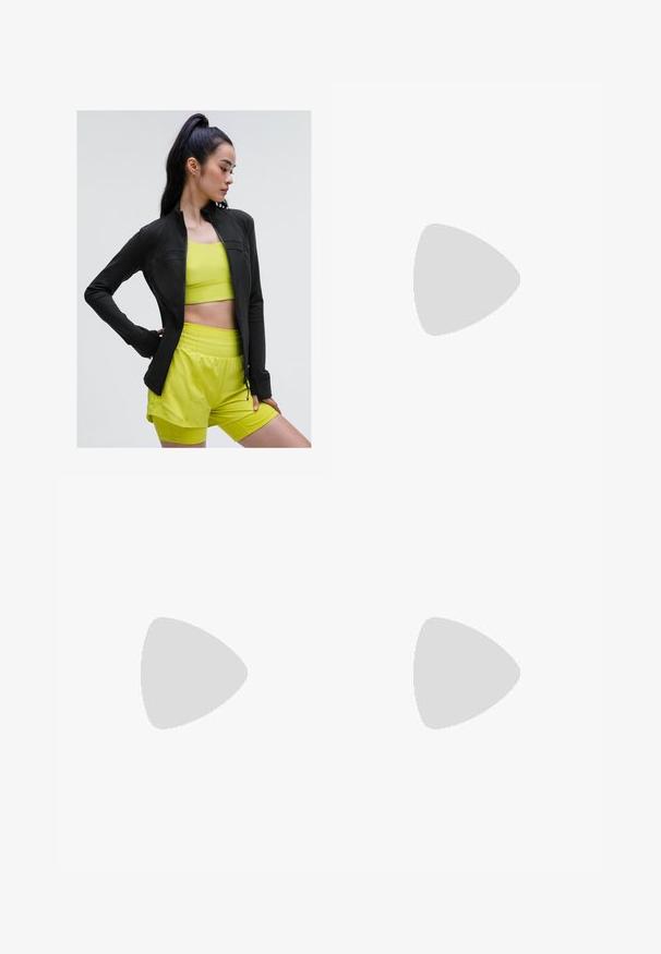 Schwarze, zipfelige Sportjacke mit figurbetontem Design, getragen über einem hellgelben, kurz geschnittenen Top und passenden Shorts, alles aus glattem, dehnbarem Material.; Schwarzes sportliches Crop-Top mit Reißverschluss vorne, Netz-Akzenten und figurnaher Passform. Hergestellt aus dehnbarem, atmungsaktivem Material. Nike-Logo auf der Vorderseite.; Schwarze, cropped Leggings aus dehnbarem Material, mit einem hohen Bund und glatter Textur, ohne sichtbare Muster oder Hardware.; Schwarze Sportschuhe aus strukturiertem Stoff, mit Schnürdesign und auffälliger Sohle, kombiniert mit weißen gerippten Socken, die ein kleines Logo tragen.