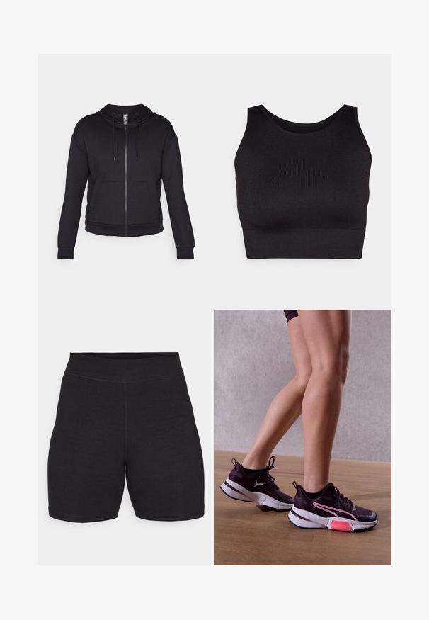 Black zip-up hoodie made of soft fabric, featuring a lined hood, drawstring, front pockets, and ribbed cuffs and hem.; Black ribbed crop top with a high neckline and wide armholes, featuring a soft, stretchy fabric for comfort and a seamless design.; Black cycling shorts with a high waist, made of stretchy, soft fabric. Features flat seams and a smooth texture for comfort.; Legs wearing purple Puma sneakers with white soles and pink accents, standing on wooden floor against a gray wall.