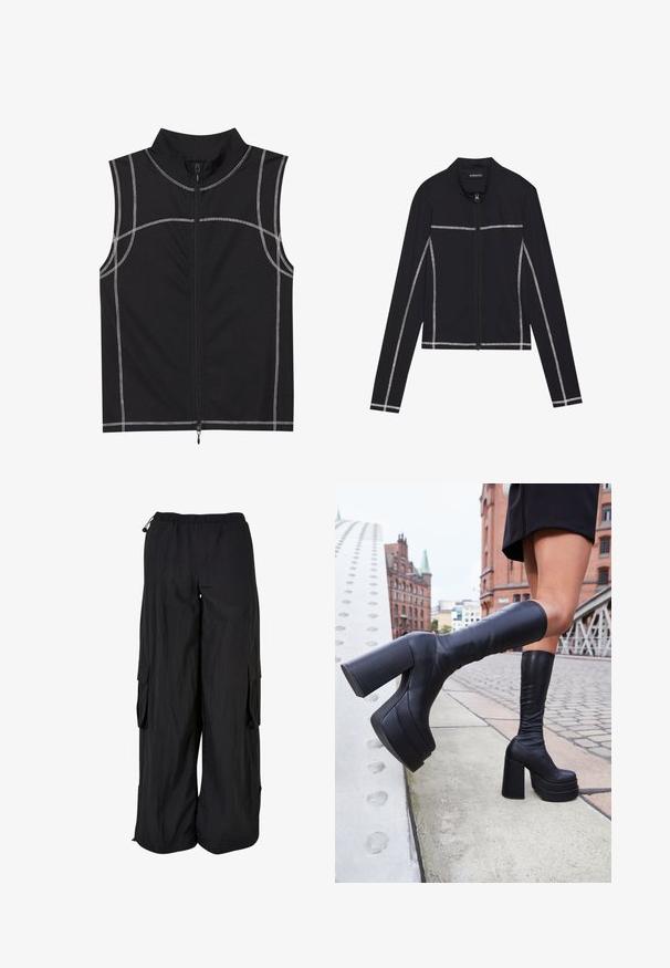 Even&Odd Sweatjacke - black; Schwarze ärmellose Weste aus einem glatten Stoff, mit silberner Nahtdetails und einem Reißverschluss vorne, entworfen mit einem hohen Kragen.; Schwarze Cargo-Hosen mit elastischem Bund, lockerer Passform, leichtem Stoff, Seitentaschen und dezent strukturiertem Finish.; Schwarze knöchelhohe Plateaustiefel aus glattem Leder, mit dicken quadratischen Absätzen und einem eleganten Design, vor einer Stadtkulisse.